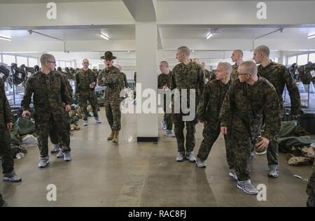 Ein Senior drill instructor mit Alpha Company, 1 Recruit Training Bataillon, beauftragt seine Rekruten während der Abholung im Marine Corps Recruit Depot San Diego, 13. Während der ersten Stunden der Bohrer Ausbilder mit Ihren neuen Rekruten sind sie werden sie lehren die hauseigene Verfahren müssen Sie für den Rest des Trainings zu rekrutieren. Jährlich mehr als 17.000 Männer aus den westlichen Recruiting Region rekrutiert werden an MCRD San Diego ausgebildet. Alpha Company ist Absolvent 7. April geplant. Stockfoto