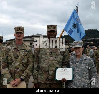 Spc. Anthony Kemp (Mitte) zeigt seine Army Achievement Medal Zitat als er mit 1st Sgt steht. Jerry Tuttle und Kapitän Elizabeth Collins, Co.D, 29 Bde zugeordnet. Engineer Bn., 3 Bde. Combat Team, 25. Inf. Div. Kemp, ein Eingeborener von Miami, Fla., gerenderte lebensrettende Hilfe durch Anlegen einer Staubinde verletzten Zivilisten in Wahiawa am Dez. 2, 2016. Stockfoto