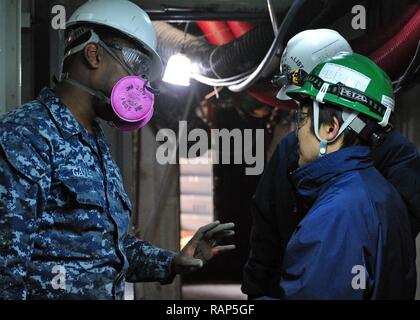 YOKOSUKA, Japan (Feb. 22, 2017) - Hospital Corpsman 3. Klasse Patrick Gayle von Jacksonville, Fla., USA 7 Flotte Flaggschiff USS Blue Ridge LCC (19), spricht mit Personal aus der Schiffsreparatur Standort Yokosuka. Blue Ridge ist in eine umfassende Wartung, um das Schiff weiterhin als eine robuste Kommunikation Plattform in den USA 7 Flotte Einsatzgebiet zu dienen zu modernisieren. Stockfoto