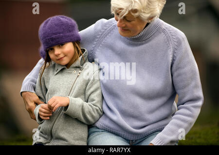 Kleines Mädchen umarmte, von ihrer Großmutter. Stockfoto