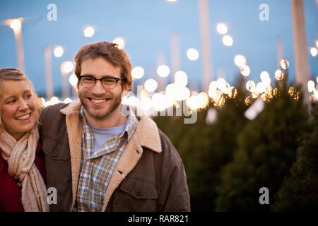 Paar in Weihnachtsbaum sehr anhänglich. Stockfoto