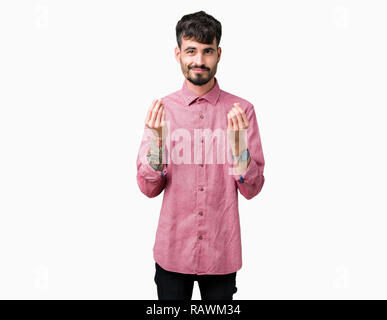 Jungen gutaussehenden Mann mit rosa Shirt über isolierte Hintergrund tut, um Geld Geste mit der Hand und bittet für Gehaltszahlungen, Millionär Business Stockfoto