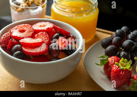 Frühstück mit Obst, Orangensaft und Joghurt auf einem Holz Tisch Stockfoto