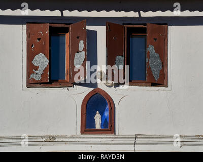 Eine Statue der Maria in einer Wand eines alten Hauses Stockfoto