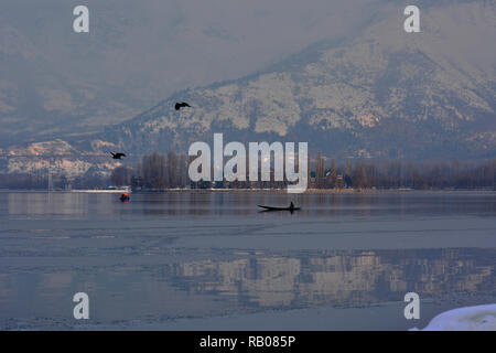 Srinagar, Jammu, Kaschmir, Indien. 5 Jan, 2019. Ein bootsmann Zeilen sein Boot nach dem Schneefall in Srinagar, die Hauptstadt des indischen Teil Kaschmirs gesteuert. Kaschmir seine ersten Schneefall erlebt. Credit: Masrat Zahra/ZUMA Draht/Alamy leben Nachrichten Stockfoto