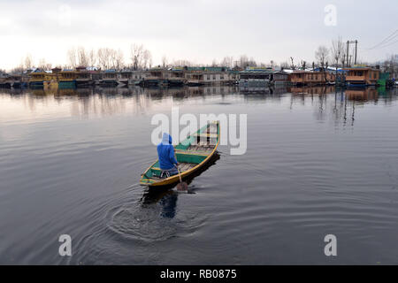 Srinagar, Jammu, Kaschmir, Indien. 5 Jan, 2019. Ein bootsmann Zeilen sein Boot nach dem Schneefall in Srinagar, die Hauptstadt des indischen Teil Kaschmirs gesteuert. Kaschmir seine ersten Schneefall erlebt. Credit: Masrat Zahra/ZUMA Draht/Alamy leben Nachrichten Stockfoto