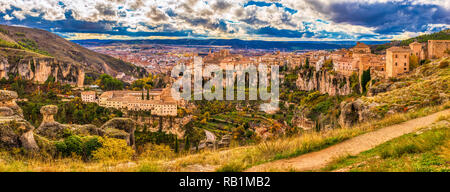 Ein Panoramablick auf die Tagesansicht des Cuenca Spanien von der Oberseite der bergigen Gegend, wo die Burg mit Wolken und Grün zusammen mit den alten befindet Stockfoto