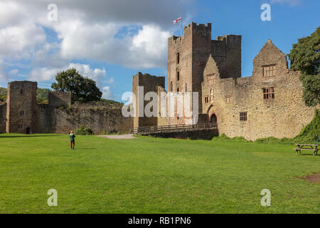 Eine Frau nimmt ein Foto der Halten bei Ludlow Castle im Herbst Sonnenschein, Shropshire, Großbritannien Stockfoto