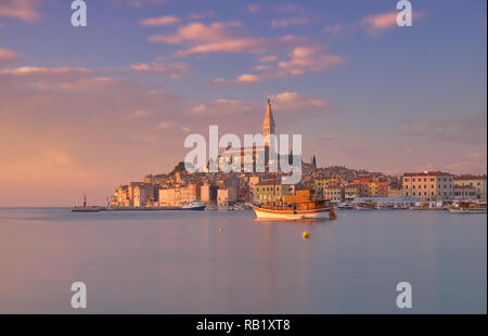 Blick auf die Stadt Rovinj in Kroatien. Rosa licht Sonnenuntergang mit langen Belichtungszeiten erzeugen Bewegung in Boote im Hafen Stockfoto