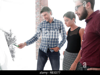 Glückliche Menschen in kariertem Hemd im Büro in der Nähe von Flipchart Stockfoto