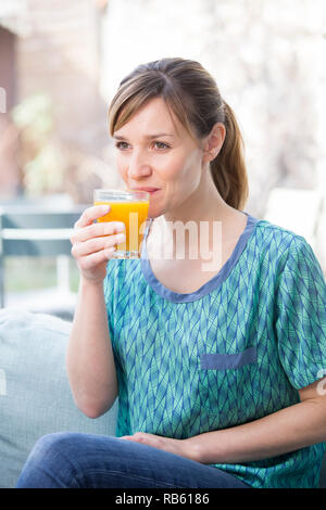 Frau trinkt Saft aus frischen Früchten. Stockfoto