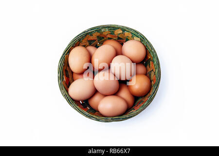 Große, braune Eier aus Freilandhaltung in einem farbigen rustikalen Weidenkorb Stockfoto