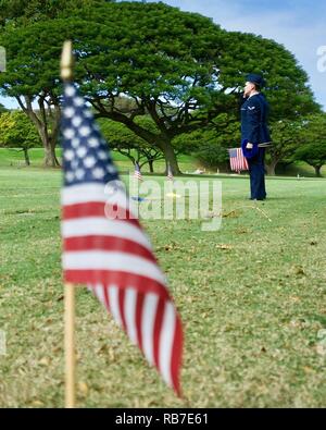 Us Air Force Staff Sgt. Johnnie Anderson und Flieger 1. Klasse Andrew Titus, Zahntechniker mit dem 15 Aeromedical Squadron, Gruß von einem gefallenen US-Servicemember gravemarker in der Nationalen Gedenkstätte Friedhof der Pazifik, Honolulu, Hawaii, Dez. 3, 2016. Anderson und Titus platziert mehrere Markierungen während einer Gedenkveranstaltung zu Ehren der Mut, Service und Opfer des US-Militärs, die während der Angriffe auf Pearl Harbor und Oahu am 7. Dezember 1941 starb. Dez. 7, 2016 ist der 75. Jahrestag der Angriffe und die US-Militärs und der Zustand von Hawaii sind für das Hosting einer se Stockfoto