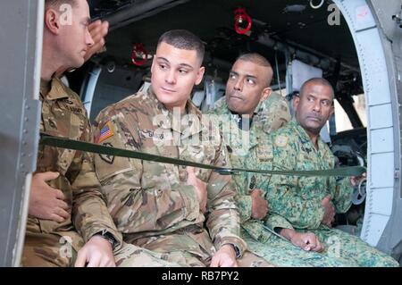 Sgt. 1. Klasse Christopher L. Gauger, einem zivilen Angelegenheiten team Sergeant mit der 412 zivilen Angelegenheiten Battalion (Airborne), geht durch einen Probelauf für das Springen von einem UH-60 Blackhawk Hubschrauber mit der Singapur springen Team während des Betriebs Spielzeug Drop in Fort Bragg, N.C., Dezember 7. Gauger, Columbus, Ohio, Bewohner sagte, ist es gut, mit ausländischen Partnern zu arbeiten, damit er besser zu verstehen, können die kulturellen Aspekte sowie in der Lage zu sehen, wie Sie innerhalb Ihrer Einheiten bedienen. Stockfoto