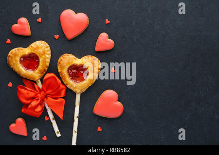 Valentine herzförmige Erdbeertorte Pops oder Kuchen erscheint auf schwarzem Hintergrund. Urlaub verkauf Konzept. Stockfoto