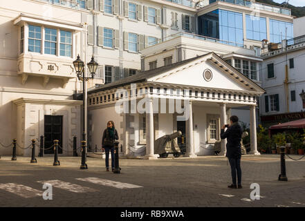 Gibraltar Rock. Zwei junge Touristen vor dem Kloster Wachhaus an der Hauptstraße, Britisches Territorium in Übersee, Großbritannien, Gibraltar, Großbritannien. Stockfoto