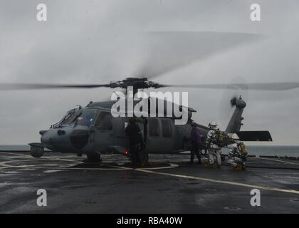 Atlantik (31. 20, 2016) Seaman Rudolph Coetzee tankt ein MH-60S Seahawk Hubschrauber während Segler stehen Brandwache auf dem Flugdeck der Amphibischen dock Landung Schiff USS Langley (LSD 41). Whidbey Island ist als Teil des Wasp amphibischen bereit, die Abgabe ist der 22. MEU nach Abschluss einer sechsmonatigen Einsatz in die USA am 5. und 6 Flotte Bereiche eingesetzt. Stockfoto