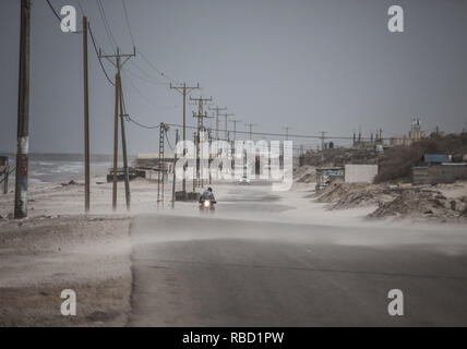 Gaza, Gaza, Palästina. 8 Jan, 2019. Palästinenser Spaziergang auf der Strandpromenade Gehweg während ein Staubsturm in Gaza Stadt. Credit: Mahmoud Issa/Quds Net News/ZUMA Draht/Alamy leben Nachrichten Stockfoto