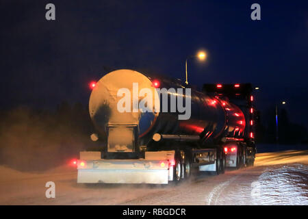 SALO, FINNLAND - Januar 16, 2016: Scania R 500 Tankwagen Fahrscheinwerfer und roten Kabinenbeleuchtung beleuchtet ein dunkles und schneereiche Winter Straße im Süden Finnlands. Stockfoto