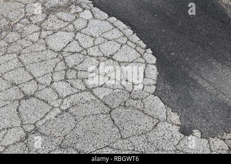 Fahrbahnoberfläche Schaden - schlechte Wartung Qualität. Asphalt Risse in Italien. Stockfoto