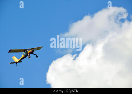 Alte gelbe Gleitschirm fliegen in den blauen Himmel mit großen weißen Wolke Stockfoto