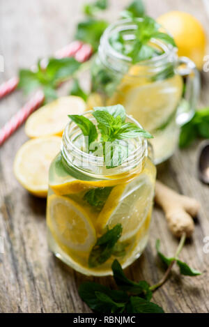 Mint Limonade Erfrischung trinken in retro Maurergläser auf rustikalen Holztisch. Gignger, Zitrone und Kräutern Zutaten für Sommer detox drink Rezept. Stockfoto