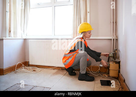 Weibliche Surveyor in harten Hut und hohe Sichtbarkeit Jacke Überprüfen der Gas- Versorgung Stockfoto