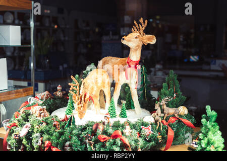 Zwei Rentiere mit Weihnachtsschmuck umgeben im Winter Urlaub Stockfoto