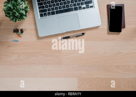 Office Desktop mit Laptop, Stift, Reisepass und Smart Phone. Ansicht von oben mit der Kopie. Stockfoto