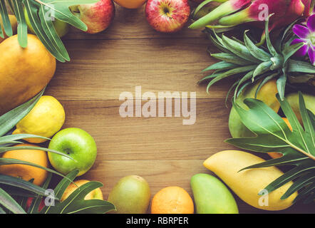 Group of fruits on wood table with space background Stockfoto
