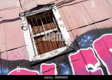 Ein Fenster eines Gebäudes mit Metallblech in Valparaiso, Chile. Stockfoto