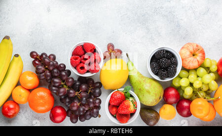 Blick von oben auf die köstlichen Früchte Himbeeren, Orangen, Pflaumen Äpfel Birnen Trauben Heidelbeeren Bananen Erdbeeren auf weißem Tabelle, Ansicht von oben, kopieren Raum Stockfoto