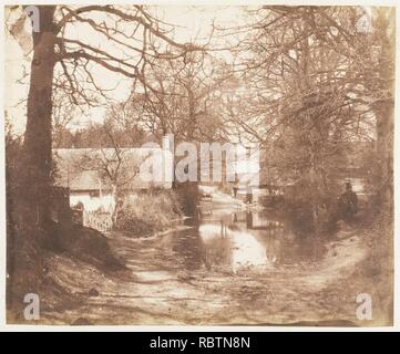 - Blick auf ein Haus im Holz, mit einem Naß-Straße Stockfoto