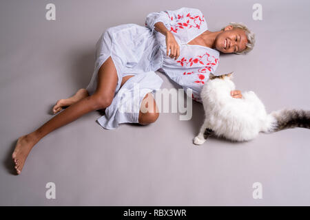 Junge schöne rebellische Frau mit kurzen Haaren, mit Persischen Katze Stockfoto