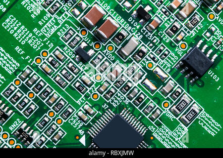 Makroaufnahme eines Circuitboard mit Widerständen Mikrochips und elektronische Komponenten. Computer Hardware Technologie. Integrierte Kommunikation Prozessor. In Stockfoto