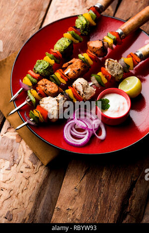 Huhn Hariyali kakab oder Malai malai Kebab serviert mit Spießen und Joghurt dip in eine Platte. selektive Fokus Stockfoto