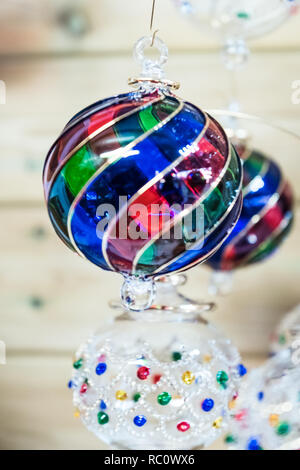 Hand bunte hängenden Christbaumkugeln geblasen. Stockfoto
