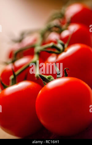 Fresh, ripe plump red truss tomatoes close up. Stockfoto
