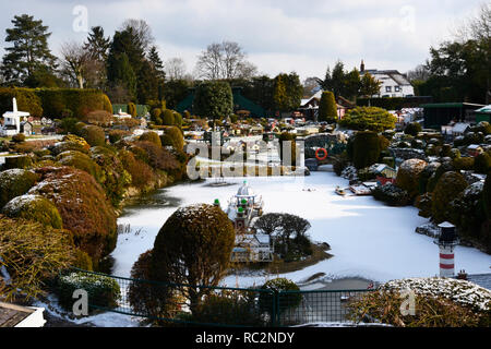 Blick über den See im Bekonscot Model Village, Beaconsfield, Buckinghamshire, Großbritannien. Schneetag im Winter Stockfoto