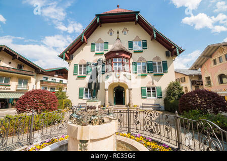 St. Gilgen, Österreich - 23 April, 2018: Mozartplatz in alpinen Stadt St. Gilgen mit einer Statue von Wolfgang Amadeus Mozart als Kind vor Rathaus Stockfoto