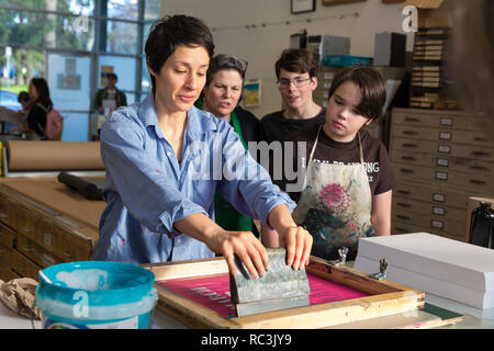 Seattle, Washington, USA. 12. Januar 2019. Künstler und Veranstalter Claire Jauregui demonstriert Siebdruck Techniken am Pratt Fine Arts Center Print Studio. Die Anhänger wurden eingeladen, positive Widerstand Plakat ausdrucken bei einer Party für die kommende Womxn im März auf Seattle 2019 erstellen. Die Rallye und März, durch Seattle Womxn marschiert vorwärts organisiert, wird am 19. Januar 2019 statt, Anpfiff ein Wochenende von Gebäude macht durch Gemeinschaft, Protest, und Aktivismus. Credit: Paul Christian Gordon/Alamy leben Nachrichten Stockfoto