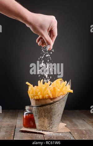 Hand eine Prise Salz hinzufügen Stockfoto