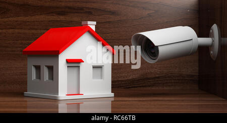 Sicherheit CCTV System und zu Hause. Überwachungskamera beobachten ein kleines Haus auf Holz- Hintergrund. 3D-Darstellung Stockfoto