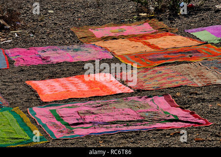 Bunte Teppiche und Decken am Ufer des Krishna und des Flusses Venna, in der Nähe des Dakshi Kashi Shiv Tempels, Mahuli Sangam, Maharashtra, Indien Stockfoto