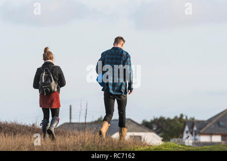 Zwei Menschen zu Fuß durch ein Feld. Stockfoto