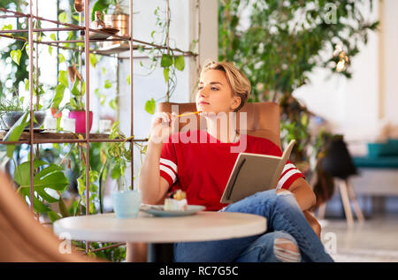 Junges Mädchen mit Notebook im Coffee Shop oder Café Stockfoto