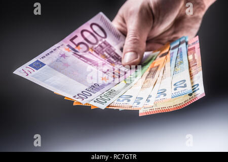 Männliche holding Euro-Banknoten in seinen Händen. Stockfoto
