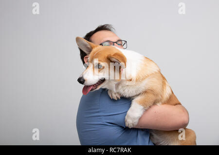 Erwachsene Mann halten corgi Hund Stockfoto