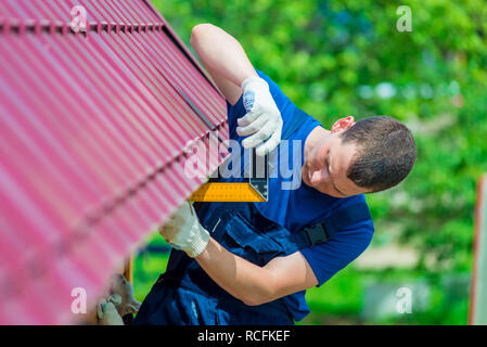 Heimwerker mit dem Werkzeug bei der Reparatur des Daches der Haus Stockfoto