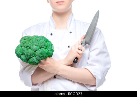 Brokkoli und einem scharfen Messer in den Händen der Köchin close-up auf weißem Hintergrund Stockfoto